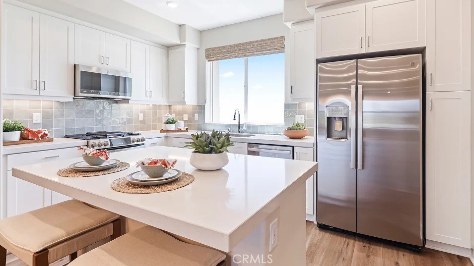 1720 East Park Lane, Unit 11 Anaheim, CA 92805 - Photo 2 of 25 a kitchen with refrigerator and cabinets