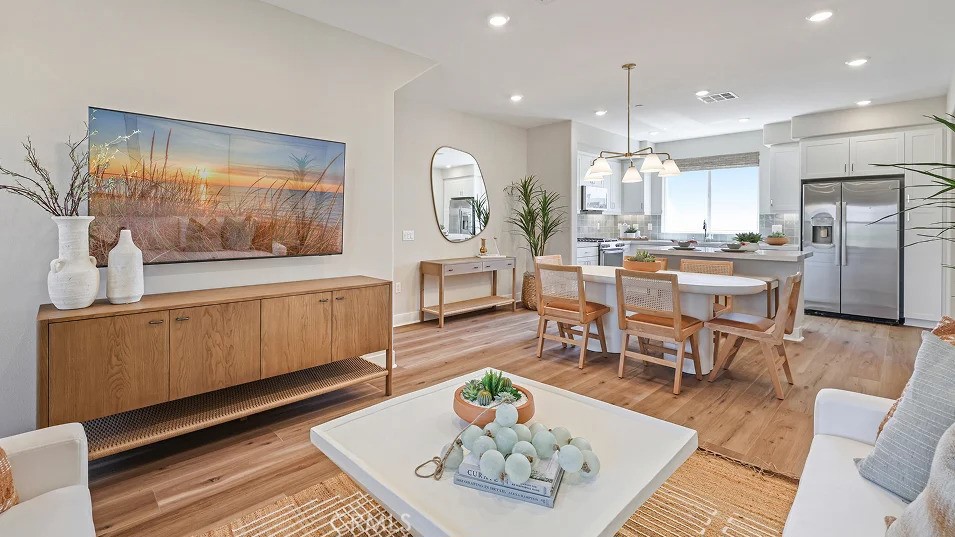 1720 East Park Lane, Unit 11 Anaheim, CA 92805 - Photo 4 of 25 a living room with stainless steel appliances furniture a rug kitchen view and a chandelier
