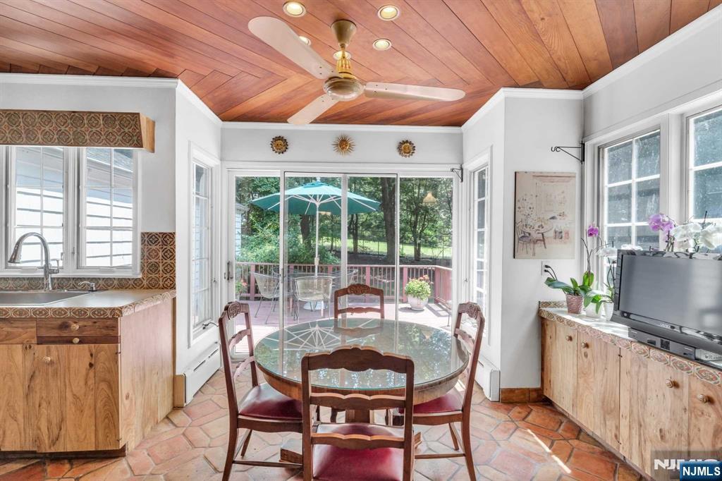 232 County Road Demarest, NJ 07627 - Photo 26 of 48 a dining room with furniture a flat screen tv and outdoor view