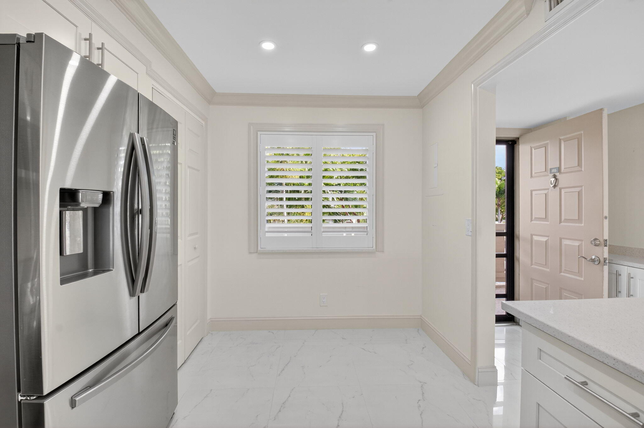 14375 Strathmore Lane, Unit 305 Delray Beach, FL 33446 - Photo 11 of 92 a view of a kitchen with a refrigerator cabinets and a window