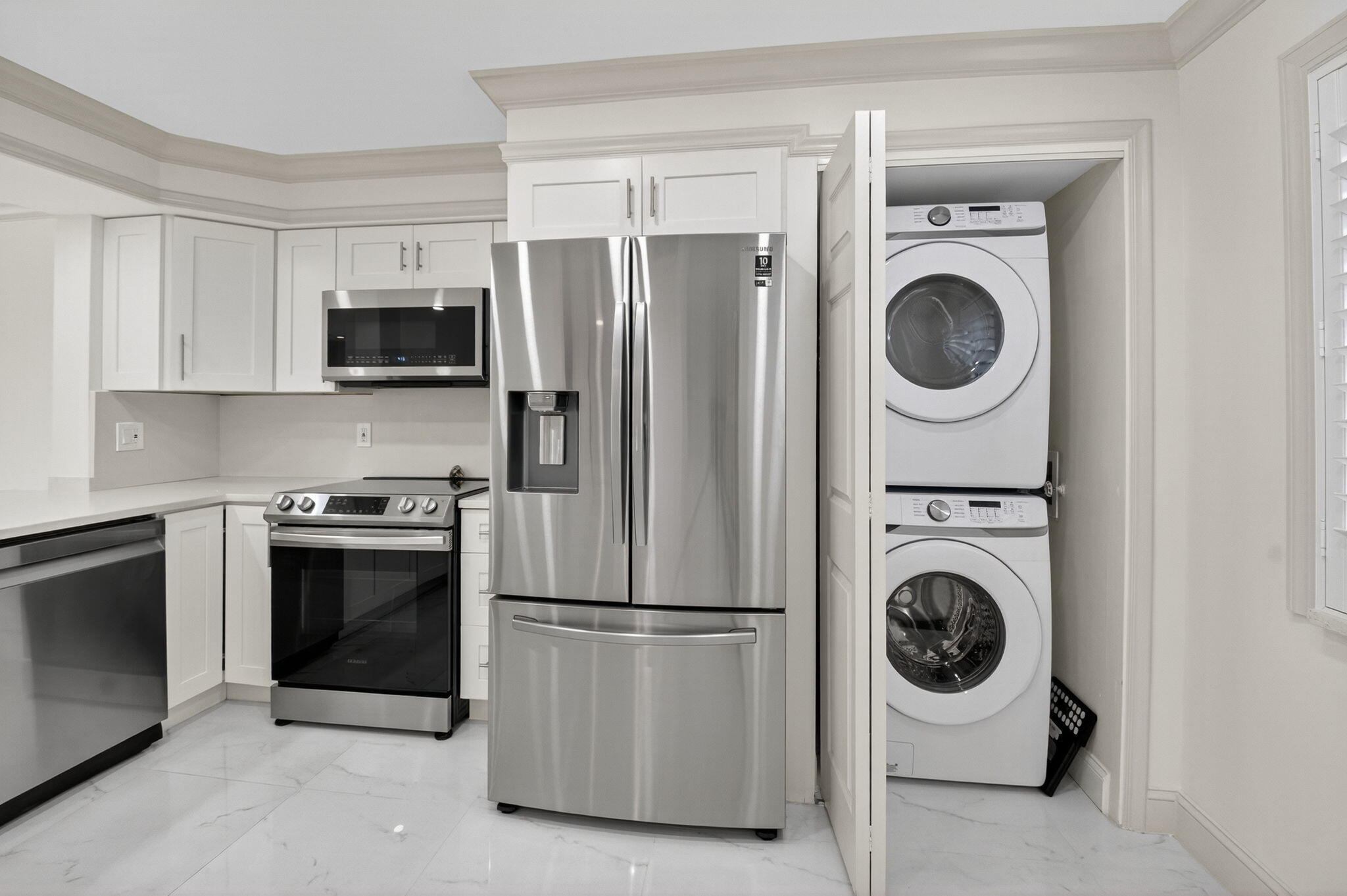 14375 Strathmore Lane, Unit 305 Delray Beach, FL 33446 - Photo 13 of 92 a kitchen with a washer and stainless steel appliances
