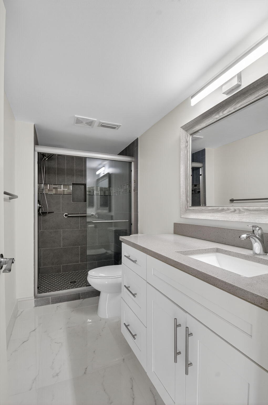 14375 Strathmore Lane, Unit 305 Delray Beach, FL 33446 - Photo 27 of 92 a bathroom with a sink a toilet and shower
