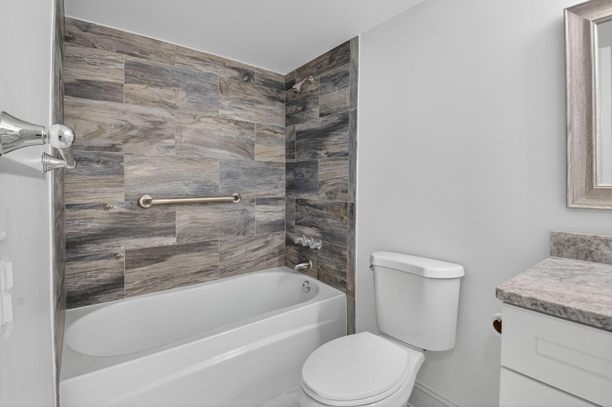 14375 Strathmore Lane, Unit 305 Delray Beach, FL 33446 - Photo 31 of 92 a bathroom with a granite countertop toilet and a bathtub