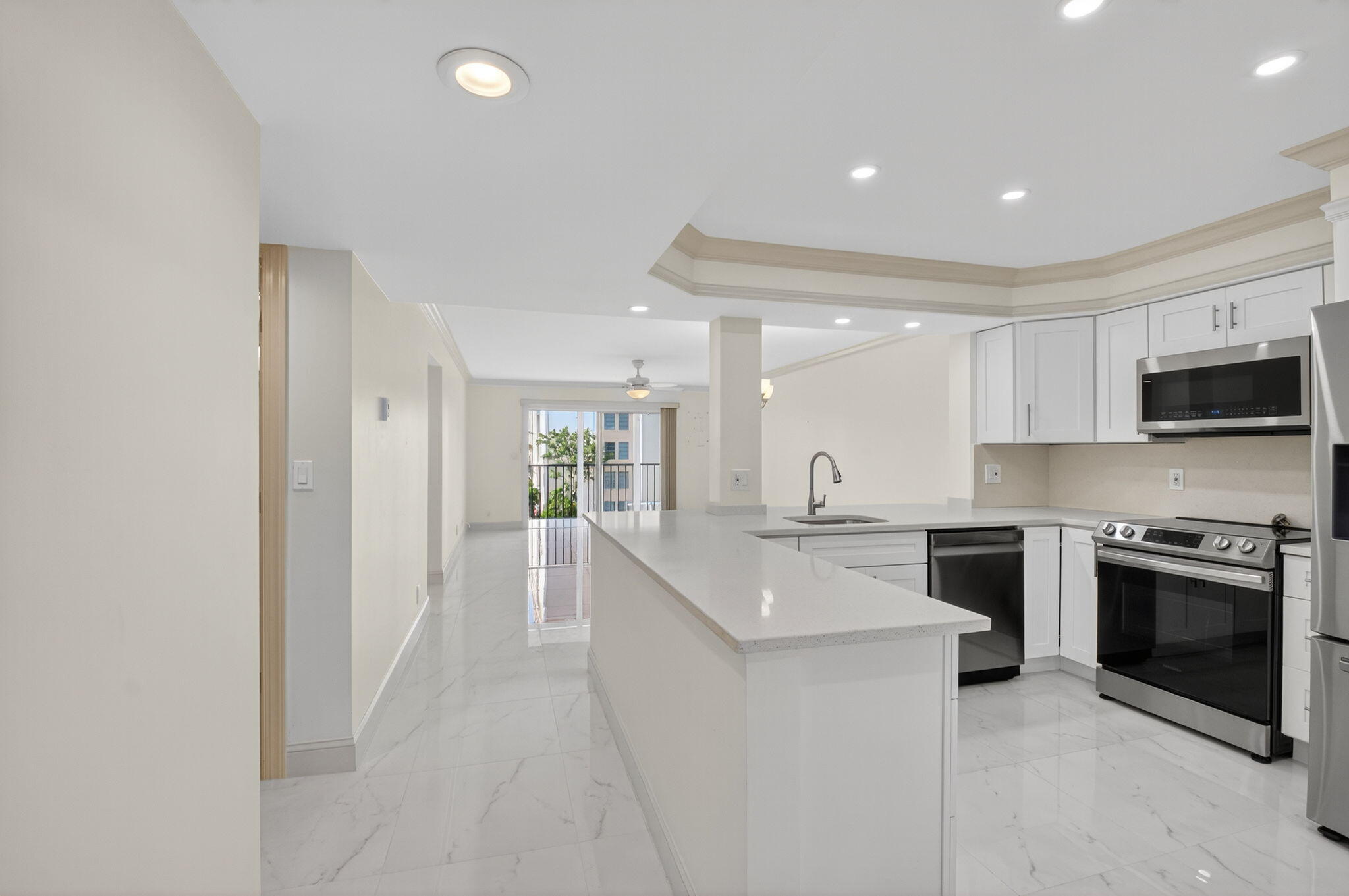 14375 Strathmore Lane, Unit 305 Delray Beach, FL 33446 - Photo 4 of 92 a large white kitchen with stainless steel appliances granite countertop a stove and a sink