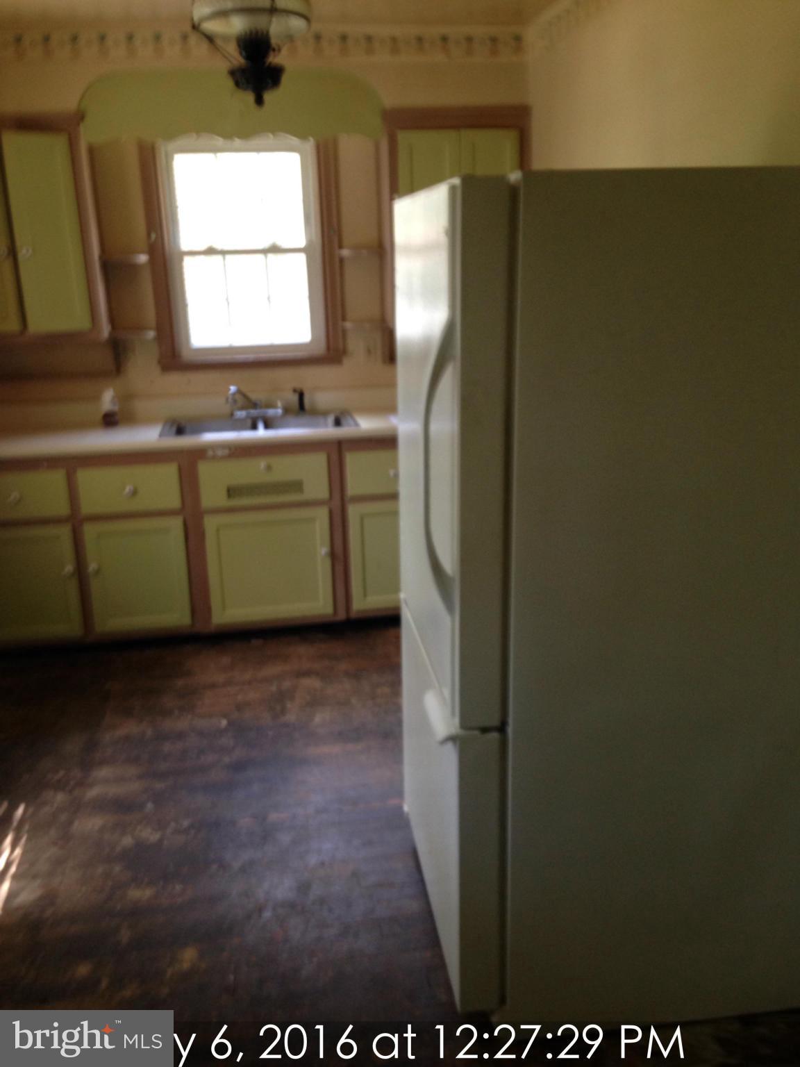 3715 Buckingham Road Baltimore, MD 21207 - Photo 4 of 9 a view of kitchen with window and refrigerator