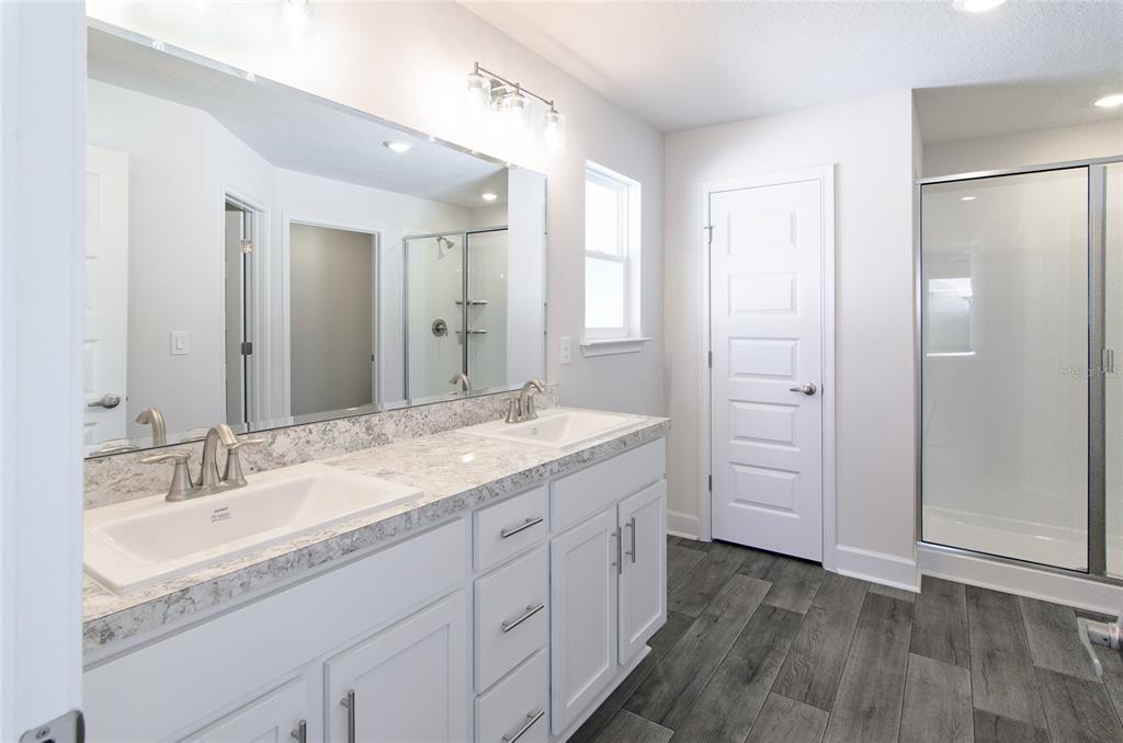 2 Seckel Court Palm Coast, FL 32164 - Photo 11 of 26 a bathroom with a granite countertop sink mirror and double