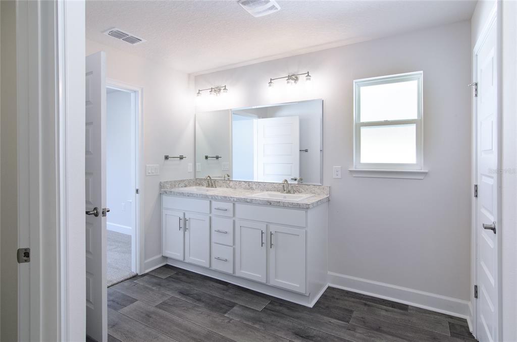 2 Seckel Court Palm Coast, FL 32164 - Photo 12 of 26 a bathroom with a granite countertop sink mirror and a toilet