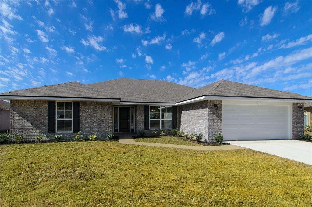 2 Seckel Court Palm Coast, FL 32164 - Photo 2 of 26 a front view of a house with a yard