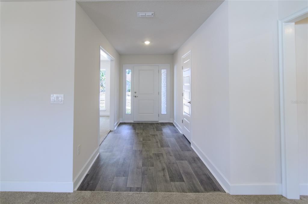 2 Seckel Court Palm Coast, FL 32164 - Photo 4 of 26 a view of gallery with wooden floor