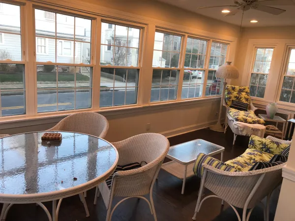 a view of a dining room with furniture large windows and wooden floor