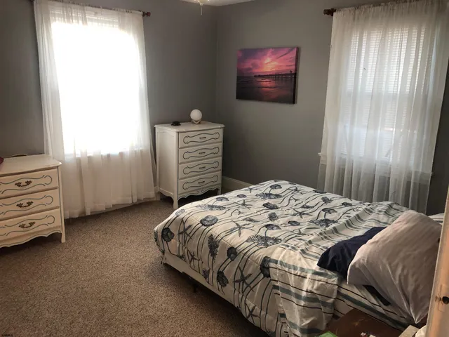 a bedroom with a bed and dresser