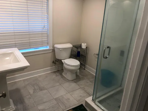 a bathroom with a toilet and a shower