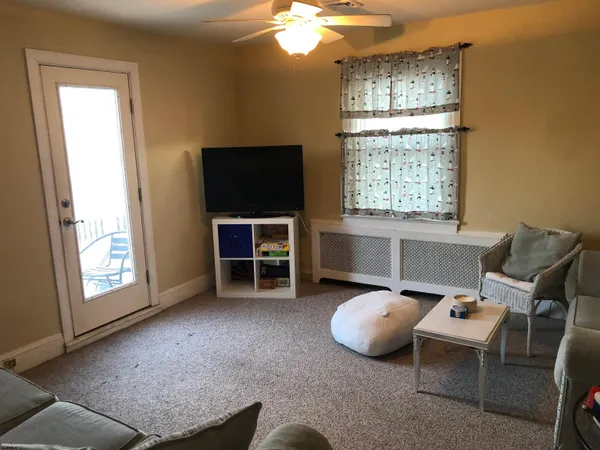 a view of a livingroom with furniture and a window