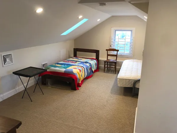 a bedroom with a bed and a chair