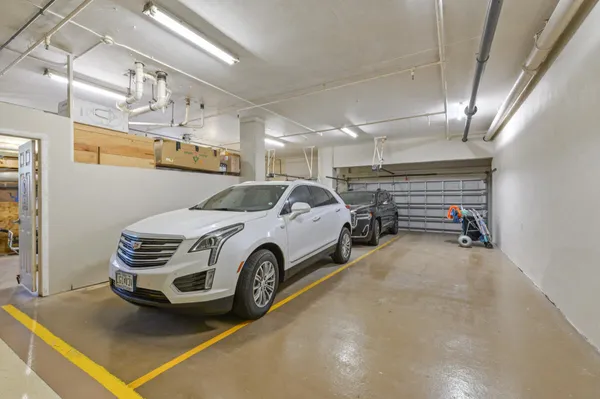 a view of parking garage with cars parked