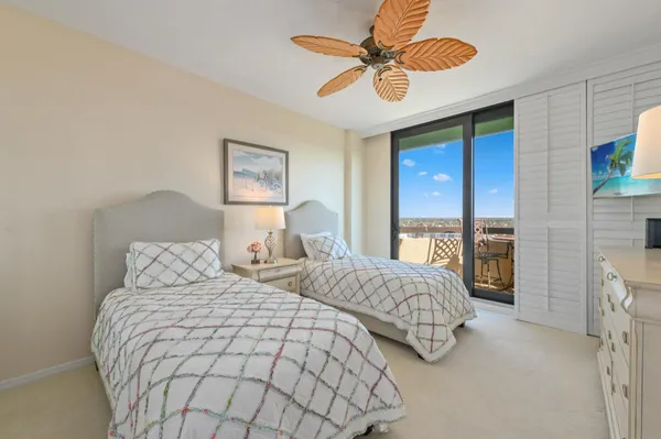 a bedroom with two beds and a chandelier