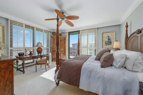a bedroom with a bed and a chandelier