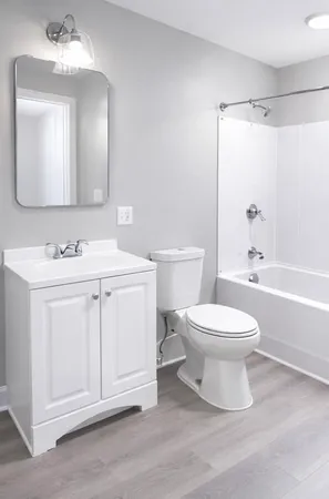 a white toilet sitting next to a bathroom sink