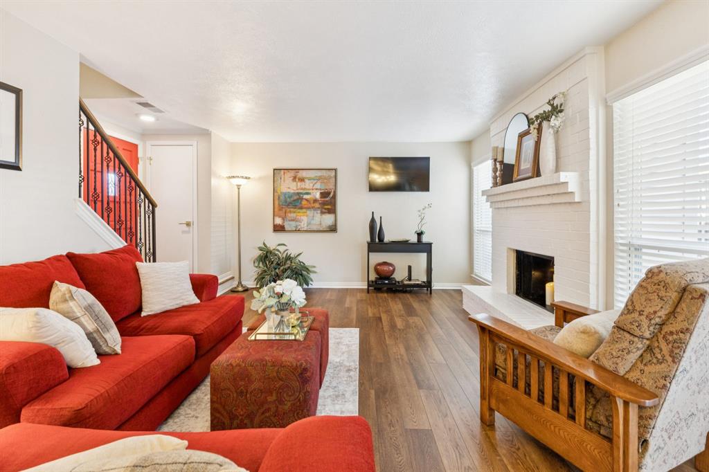 2016 Via Miramonte Carrollton, TX 75006 - Photo 11 of 34 a living room with furniture wooden floor and a fireplace