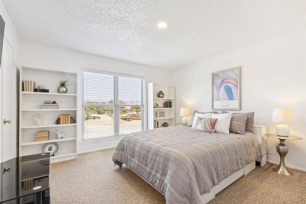 2016 Via Miramonte Carrollton, TX 75006 - Photo 18 of 34 a spacious bedroom with a bed and a large window