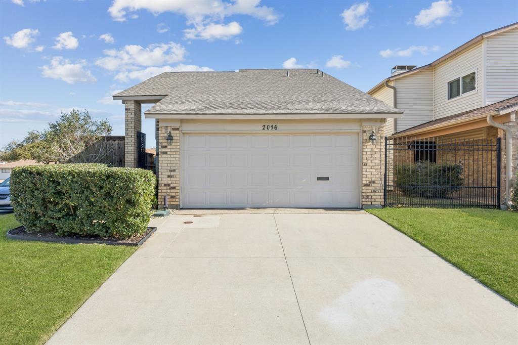 2016 Via Miramonte Carrollton, TX 75006 - Photo 3 of 34 a front view of a house with a yard and garage