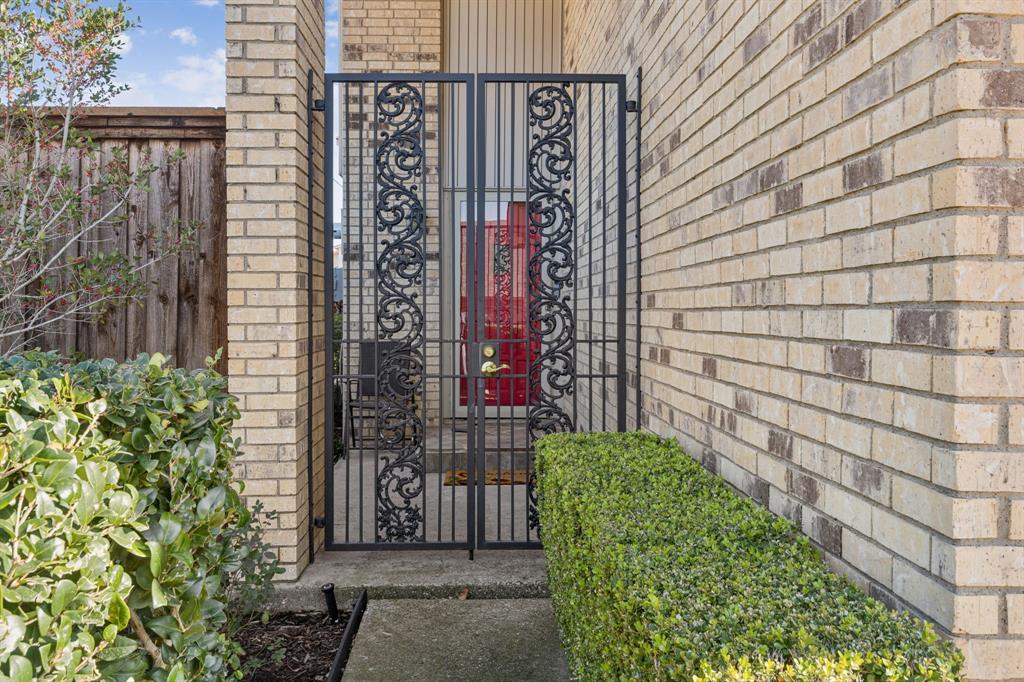2016 Via Miramonte Carrollton, TX 75006 - Photo 4 of 34 a view of a brick wall with plants and windows