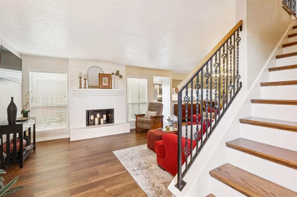 2016 Via Miramonte Carrollton, TX 75006 - Photo 7 of 34 a living room with furniture and a fireplace