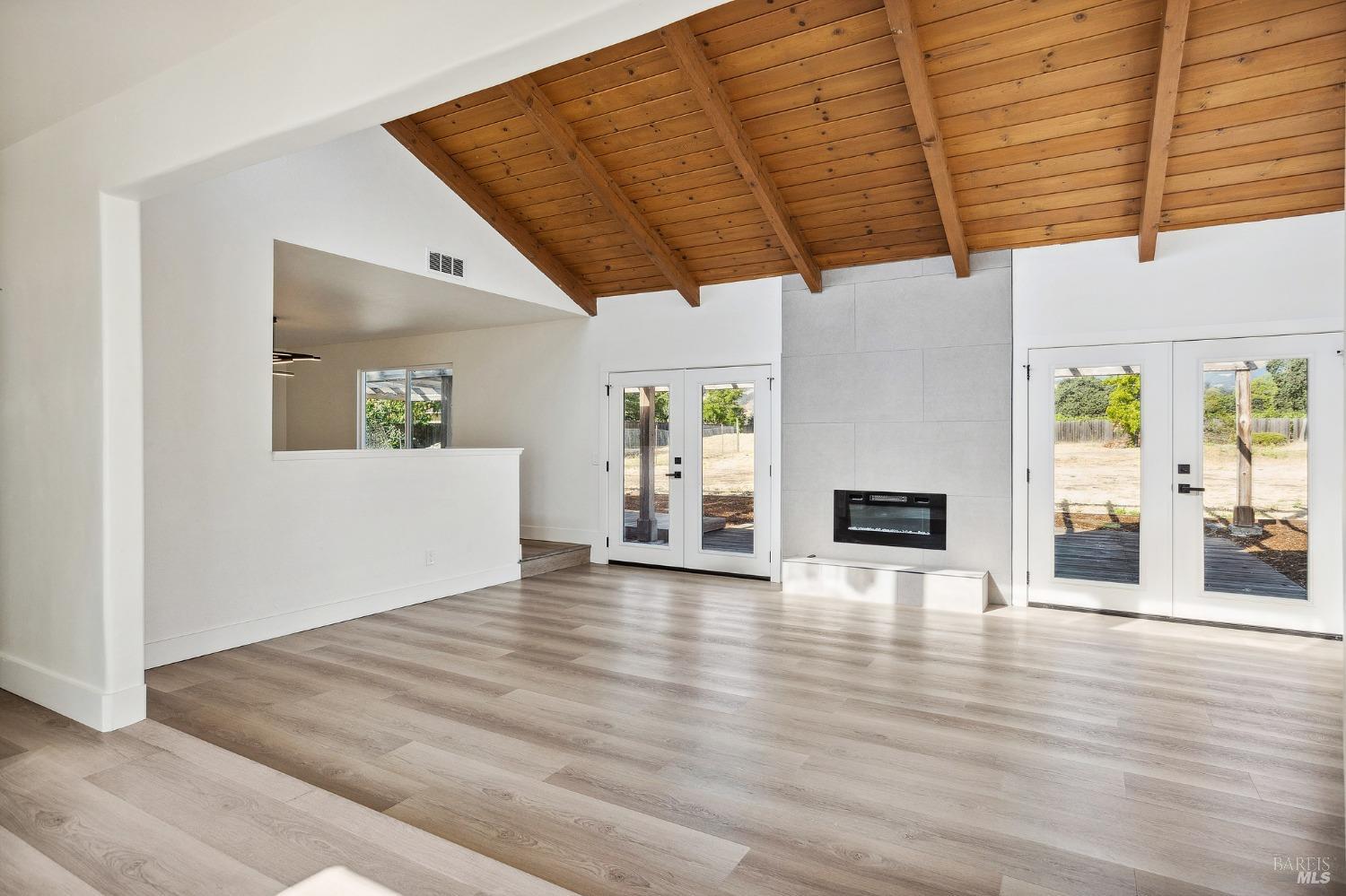 1282 Fowler Creek Road Sonoma, CA 95476 - Photo 12 of 86 a view of empty room with wooden floor and fireplace