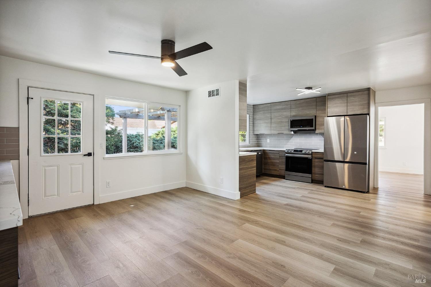 1282 Fowler Creek Road Sonoma, CA 95476 - Photo 23 of 86 a view of kitchen with stainless steel appliances wooden floor and window