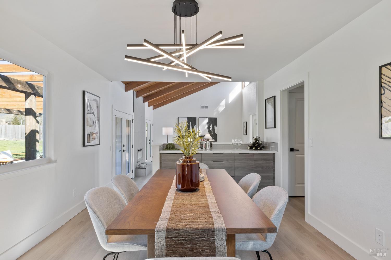 1282 Fowler Creek Road Sonoma, CA 95476 - Photo 31 of 86 a dining room with furniture a chandelier and wooden floor