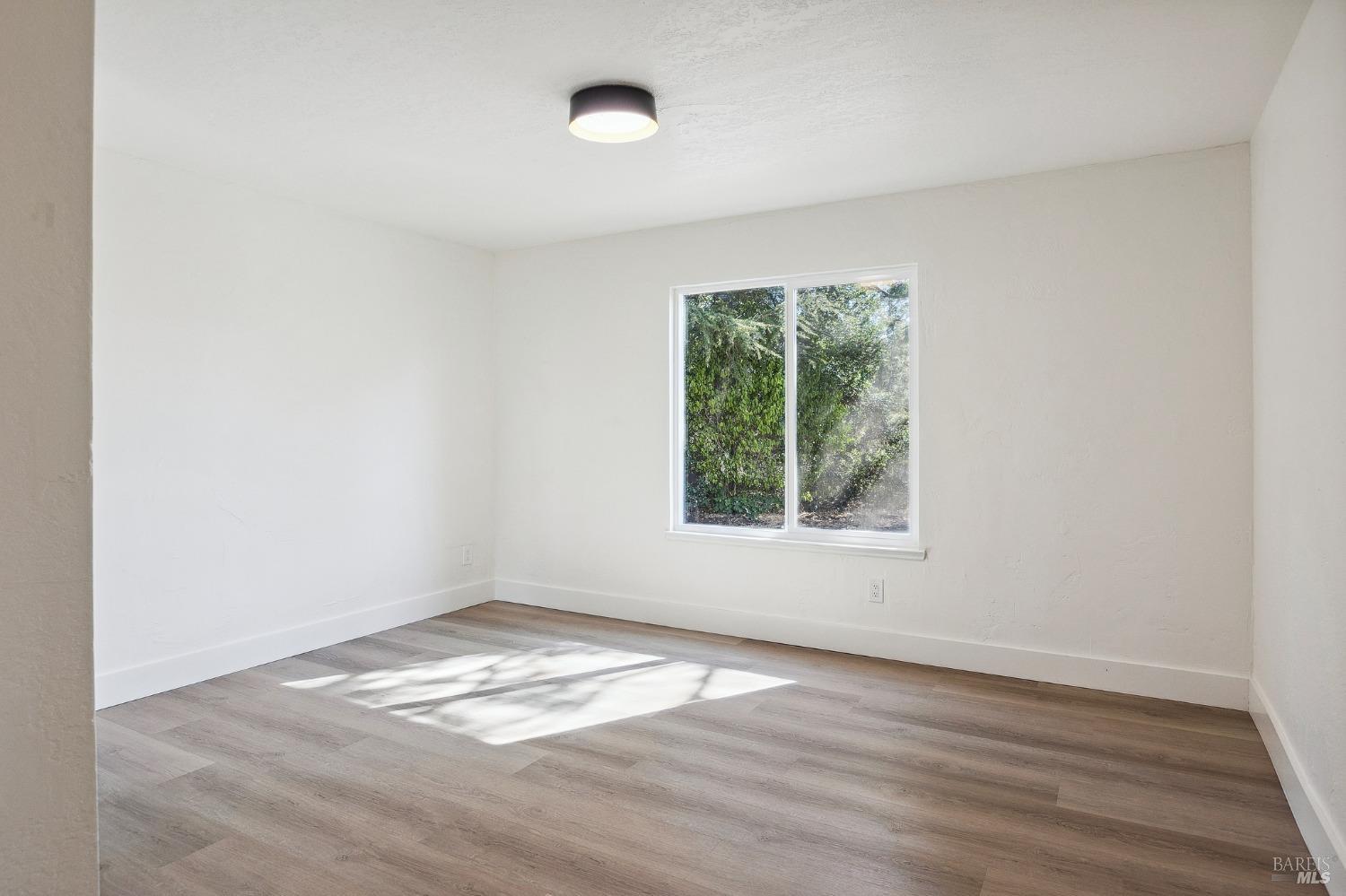 1282 Fowler Creek Road Sonoma, CA 95476 - Photo 53 of 86 an empty room with wooden floor and windows