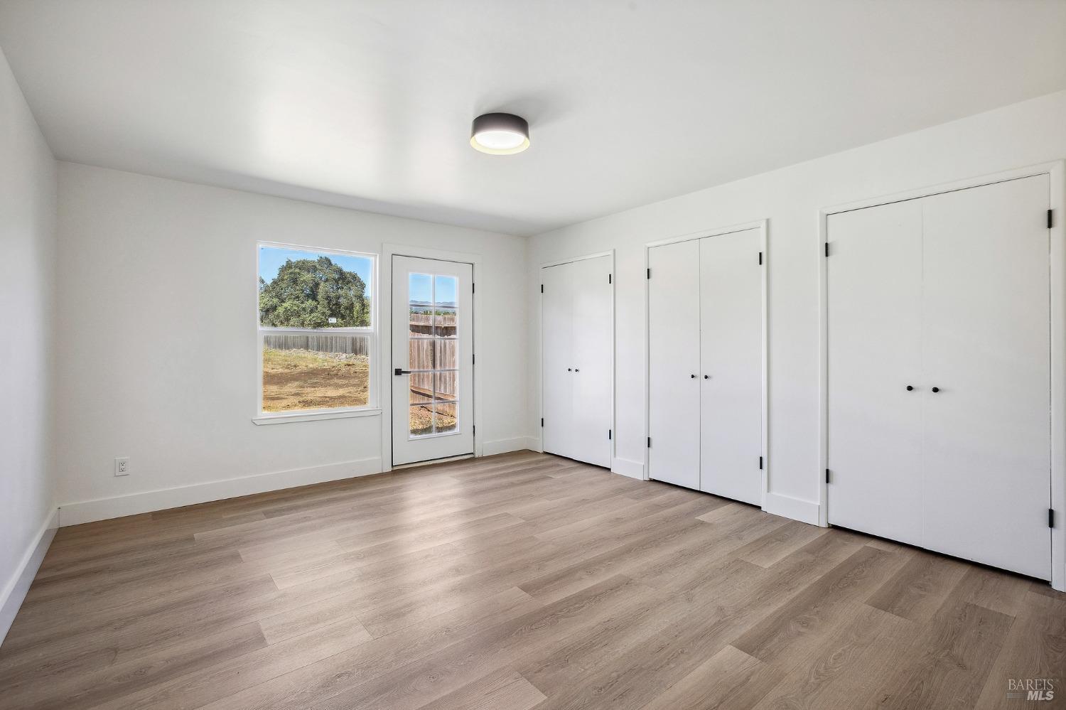 1282 Fowler Creek Road Sonoma, CA 95476 - Photo 58 of 86 a view of an empty room with wooden floor and a window