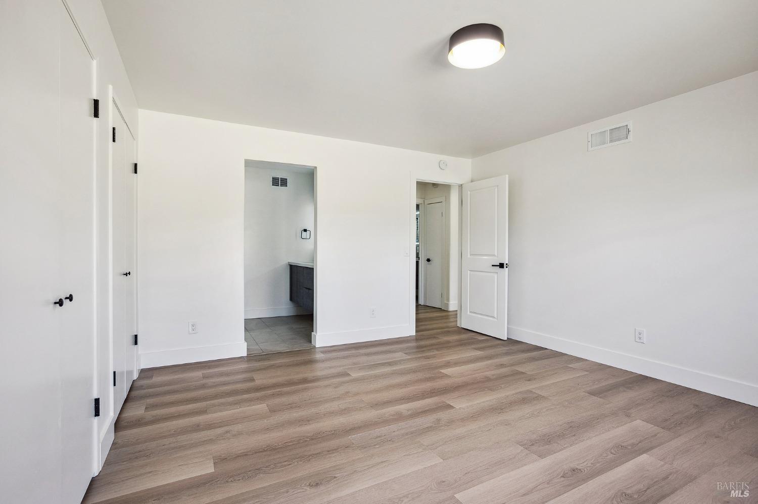 1282 Fowler Creek Road Sonoma, CA 95476 - Photo 62 of 86 a view of an empty room with wooden floor and a window