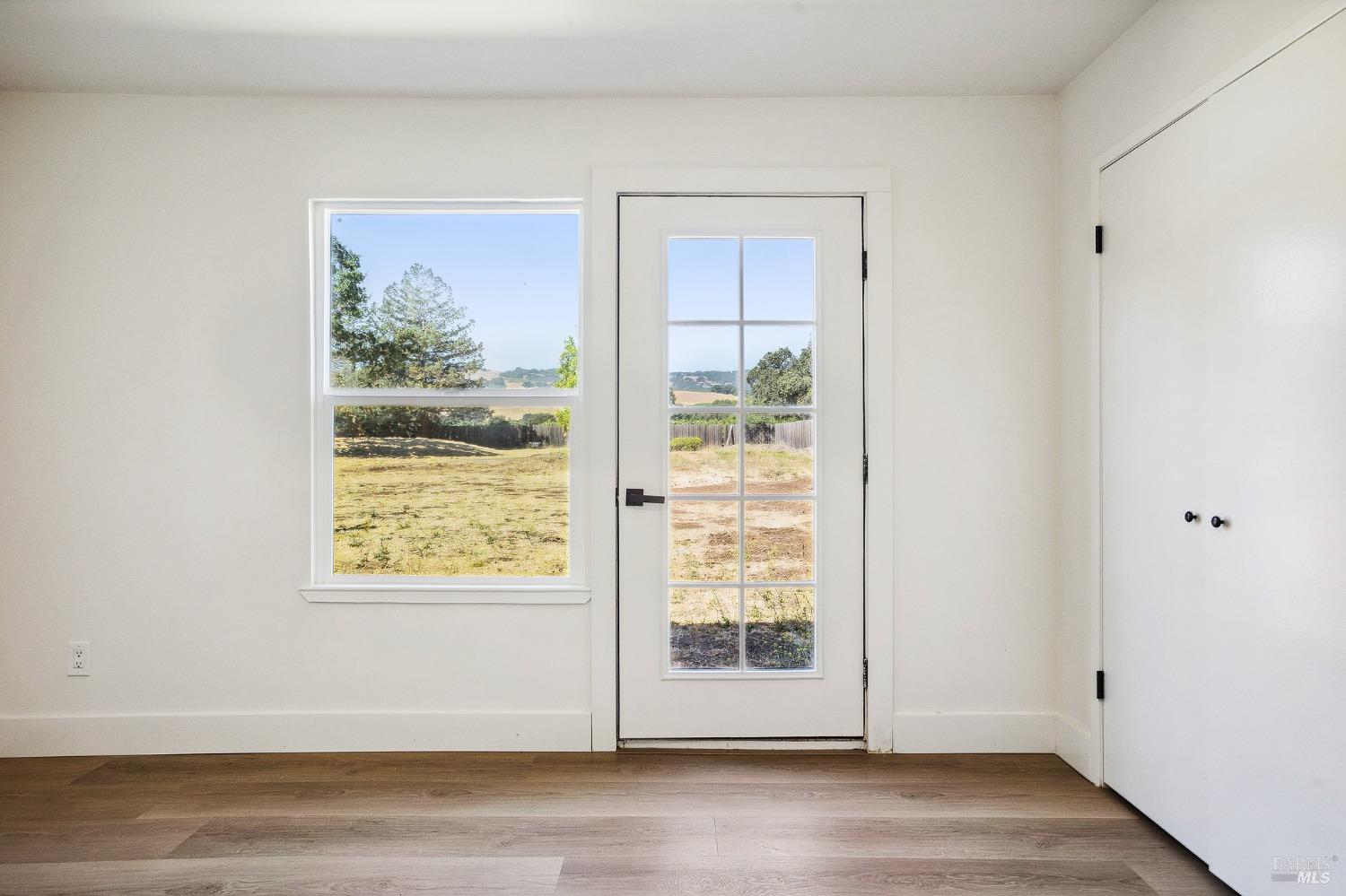 1282 Fowler Creek Road Sonoma, CA 95476 - Photo 66 of 86 a view of an empty room with wooden floor and a window