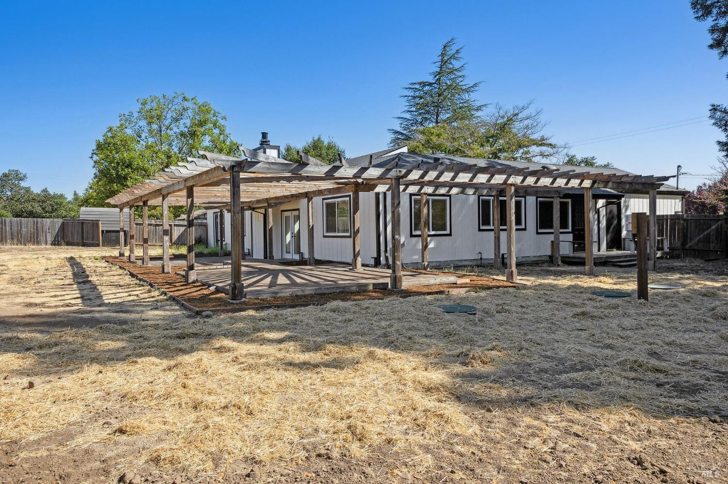 1282 Fowler Creek Road Sonoma, CA 95476 - Photo 68 of 86 a view of a white house with a yard