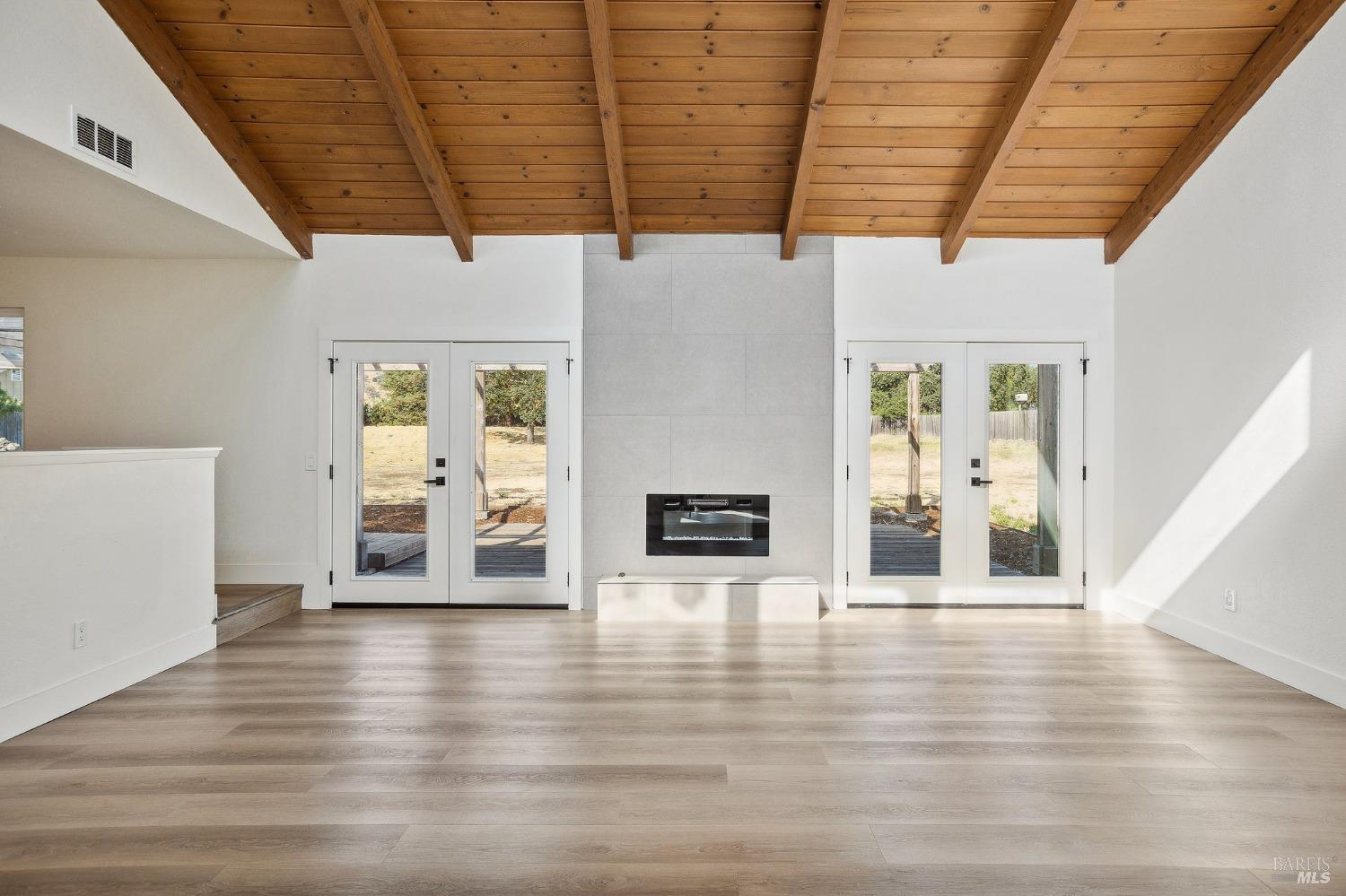 1282 Fowler Creek Road Sonoma, CA 95476 - Photo 10 of 86 a view of an empty room with wooden floor and a fireplace