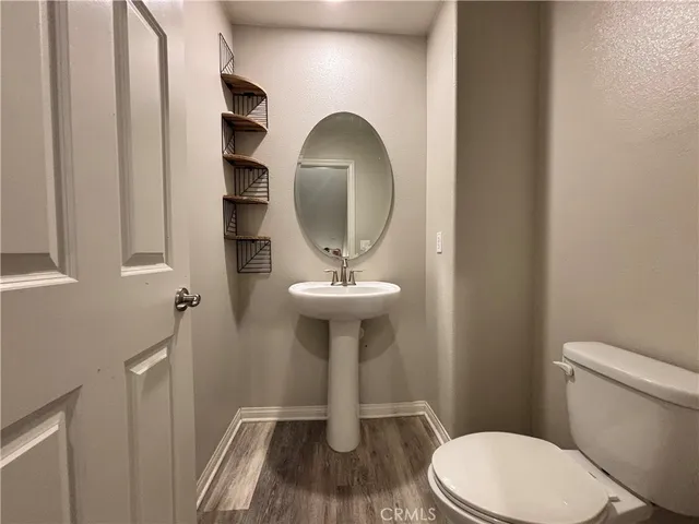 a bathroom with a toilet a sink and a mirror
