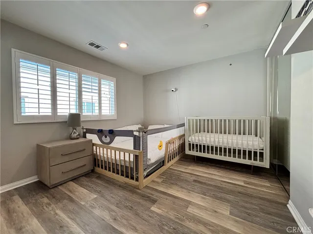 a spacious bedroom with a bed and a window
