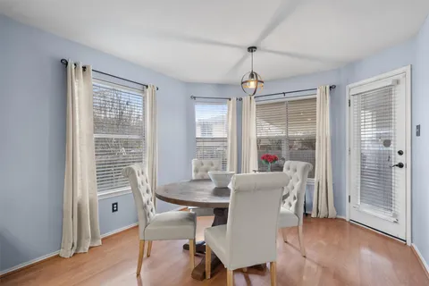 a dining room with furniture wooden floor and a chandelier