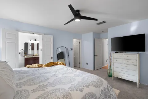 a bedroom with a bed and flat screen tv