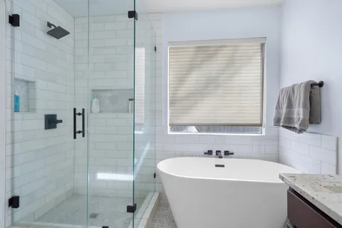 a bathroom with a bathtub and a shower