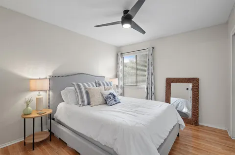 a bedroom with a bed and a lamp on table