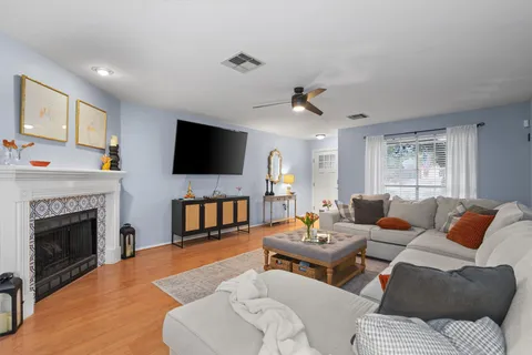 a living room with furniture a fireplace and a flat screen tv