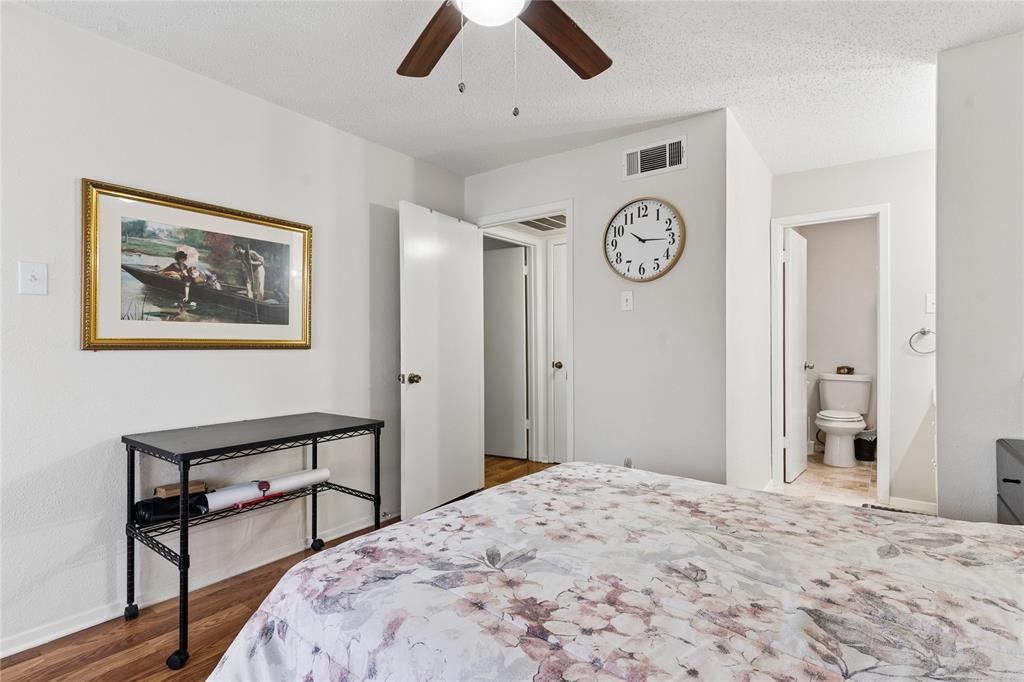 11311 Audelia Road, Unit 102 Dallas, TX 75243 - Photo 17 of 31 Wood-finish flooring with light-toned walls and a ceiling fan