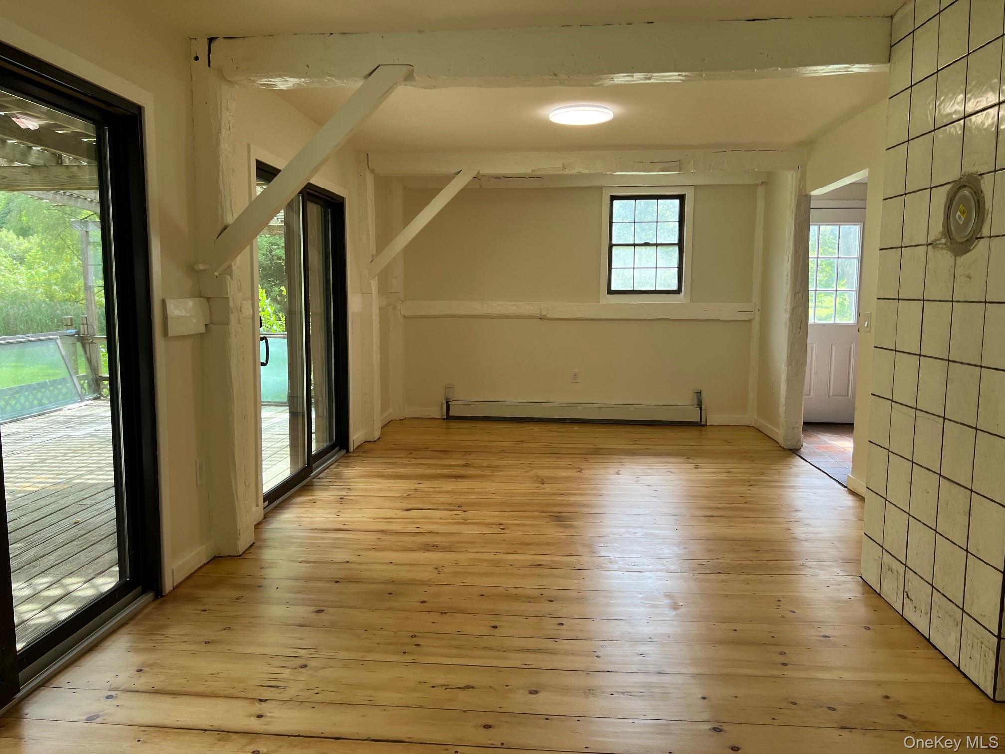 121 East Hook Cross Road Hopewell Junction, NY 12533 - Photo 4 of 16 a view of a room with wooden floor and brick walls