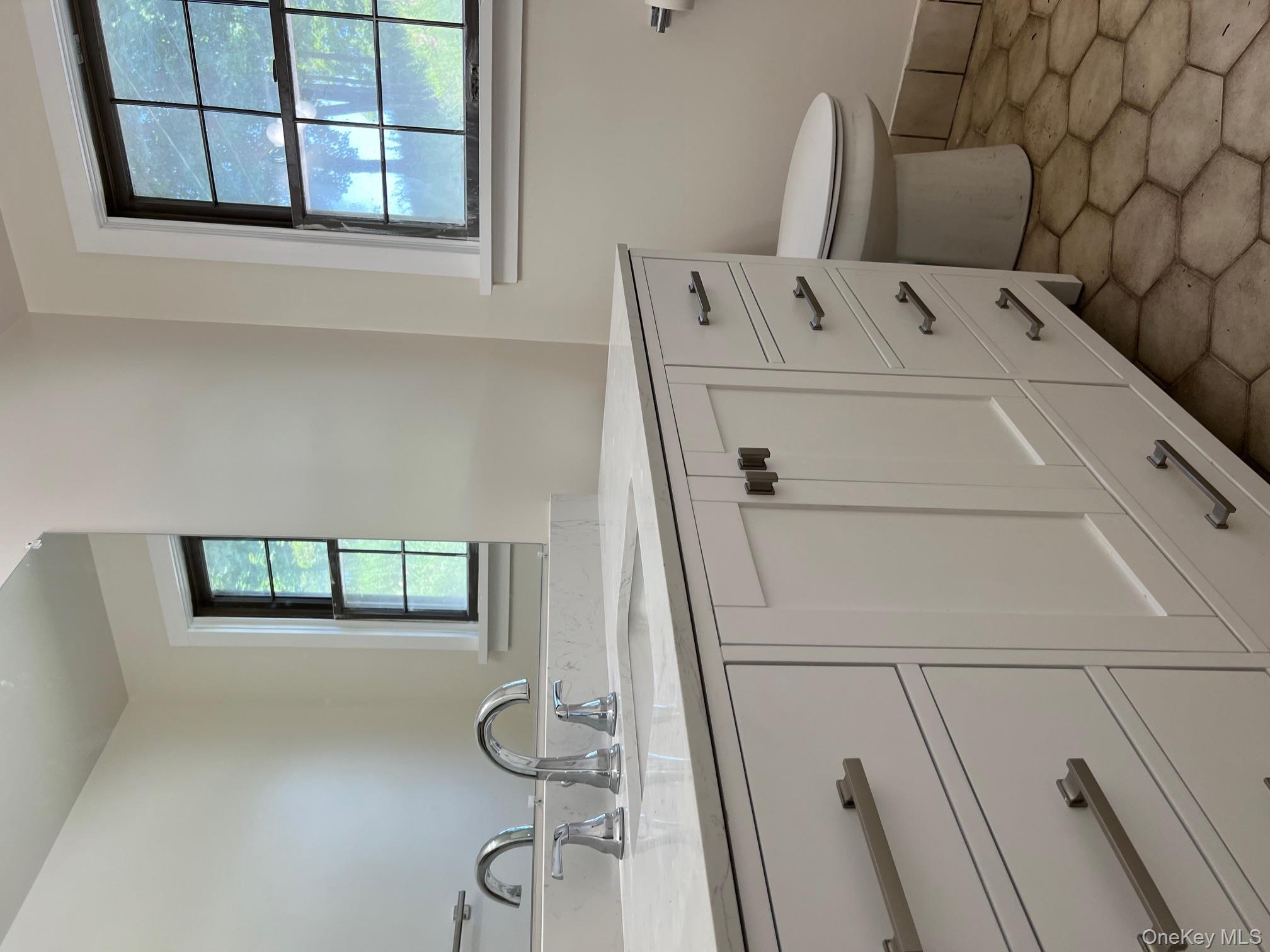 121 East Hook Cross Road Hopewell Junction, NY 12533 - Photo 10 of 16 a bathroom with a toilet sink and mirror