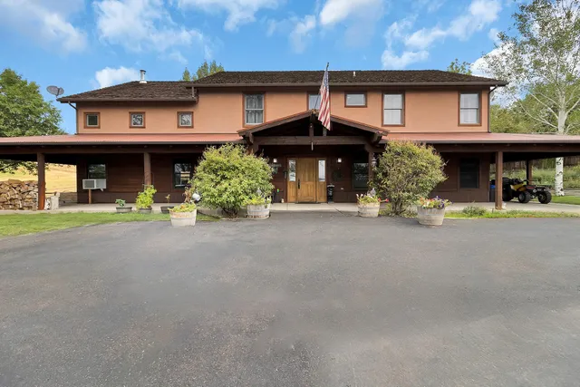 a front view of a house with a yard and a garage