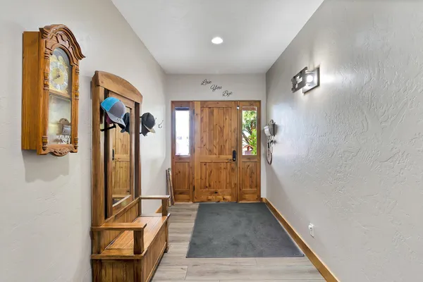 a view of a hallway with wooden floor and furniture