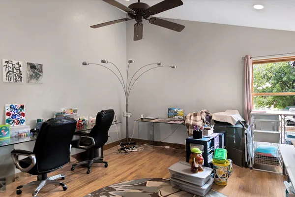 a bedroom with a bed and wooden floor