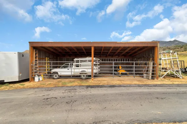 a view of a house with backyard space and balcony